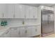 Modern kitchen with white cabinets, stainless steel refrigerator, and neutral countertops at 9632 Cherry Canyon Ave, Las Vegas, NV 89129