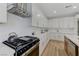 Well-lit kitchen featuring white cabinetry, stainless steel appliances, and stone countertops at 9632 Cherry Canyon Ave, Las Vegas, NV 89129