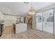 Open kitchen showcasing a large island with quartz countertops, stainless steel appliances, and wood-style floors at 9632 Cherry Canyon Ave, Las Vegas, NV 89129