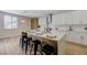 Charming kitchen island with modern appliances, countertop seating, and adjacent white cabinets at 9632 Cherry Canyon Ave, Las Vegas, NV 89129