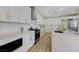 Clean kitchen featuring white cabinets, stainless steel appliances, and a large island at 9632 Cherry Canyon Ave, Las Vegas, NV 89129