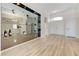 Bright living room with light wood floors, large front door, and contemporary mirrored shelving at 9632 Cherry Canyon Ave, Las Vegas, NV 89129