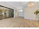 Spacious living room with light wood flooring, designer lighting, and stylish mirrored shelving at 9632 Cherry Canyon Ave, Las Vegas, NV 89129