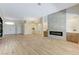 Open-concept living room with fireplace, wood floors, and views of front door and kitchen at 9632 Cherry Canyon Ave, Las Vegas, NV 89129