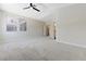 Large main bedroom showcasing neutral carpet, ceiling fan, and entry to the ensuite bathroom and closet at 9632 Cherry Canyon Ave, Las Vegas, NV 89129