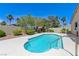 Backyard pool with clear blue water, surrounded by well-maintained landscaping and a concrete patio at 9632 Cherry Canyon Ave, Las Vegas, NV 89129