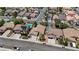 Aerial view capturing a residential street with neatly arranged homes, mature trees, and well-maintained landscaping at 9632 Cherry Canyon Ave, Las Vegas, NV 89129