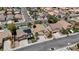 Aerial view showcases a residential area with diverse homes, mature trees, and well-planned streets in the community at 9632 Cherry Canyon Ave, Las Vegas, NV 89129
