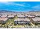 Expansive aerial view of a well-planned community with tile roofs and desert landscaping against a mountain backdrop at , Henderson, NV 89044