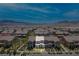 Expansive aerial view of a well-planned community with tile roofs and desert landscaping against a mountain backdrop at , Henderson, NV 89044