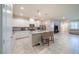 Bright, open kitchen featuring white cabinets, granite counters, and a central island at , Henderson, NV 89044
