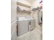 Bright laundry room with washer, dryer, and shelving for organized storage at , Henderson, NV 89044