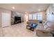 Large living room with ample seating and tile floors extending to a staircase at , Henderson, NV 89044