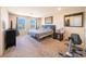 Bright main bedroom with two windows, carpet and black furniture set at , Henderson, NV 89044