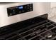 Close-up of the stainless steel stove with black grates and digital controls at , Henderson, NV 89044