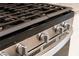 Close-up of stainless steel stove with silver knobs, detailing its sleek design at , Henderson, NV 89044
