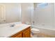 View of a bathroom featuring a vanity with a sink, toilet, and a shower over tub combo with white tile surround at 10348 Cherry Brook St, Las Vegas, NV 89183