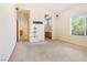 A bedroom highlighting neutral walls, carpet flooring, a window, and an open doorway to another room at 10348 Cherry Brook St, Las Vegas, NV 89183