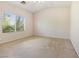 A bedroom showcasing a large window, neutral walls, and carpet flooring offering a bright and spacious atmosphere at 10348 Cherry Brook St, Las Vegas, NV 89183