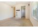 A bedroom revealing neutral walls, carpet flooring, a window, and access to another room or ensuite bathroom at 10348 Cherry Brook St, Las Vegas, NV 89183