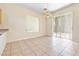 Open dining area with tile flooring, a sliding glass door to the patio, and a decorative light fixture at 10348 Cherry Brook St, Las Vegas, NV 89183