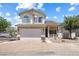 Charming two-story home featuring a two-car garage, desert landscaping, and lovely architectural details at 10348 Cherry Brook St, Las Vegas, NV 89183