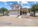 Inviting two-story home with a brick driveway, manicured landscaping, and a cozy front porch area at 10348 Cherry Brook St, Las Vegas, NV 89183