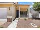 Close-up of the covered front porch with white railing, a desert landscape, and an exterior light fixture at 10348 Cherry Brook St, Las Vegas, NV 89183