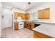 Traditional-style kitchen with wood cabinets, tile floors, and a window over the sink area at 10348 Cherry Brook St, Las Vegas, NV 89183