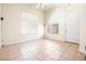 Bright living room with high ceilings, large windows, tile floors, and a neutral color scheme at 10348 Cherry Brook St, Las Vegas, NV 89183