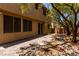 Backyard featuring desert landscaping, mature trees and shrubbery, and a brick patio at 10584 Peach Creek St, Las Vegas, NV 89179