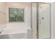 This bright bathroom features a glass-enclosed shower and soaking tub at 10584 Peach Creek St, Las Vegas, NV 89179