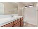 Bathroom features a vanity with drawers, a sink, tile countertop, mirror and a shower-tub combo at 10584 Peach Creek St, Las Vegas, NV 89179