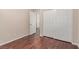 This bedroom features wood floors and a closet with doors at 10584 Peach Creek St, Las Vegas, NV 89179