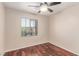 The bright bedroom features a ceiling fan and hardwood floors at 10584 Peach Creek St, Las Vegas, NV 89179