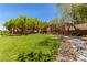 Community park with lush green grass, playground, and mature trees at 10584 Peach Creek St, Las Vegas, NV 89179