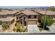 Charming home with desert landscaping, stone accents, a tile roof, and a two-car garage at 10584 Peach Creek St, Las Vegas, NV 89179