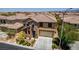Charming home with desert landscaping, stone accents, a tile roof, and a two-car garage at 10584 Peach Creek St, Las Vegas, NV 89179