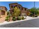 Charming two-story home featuring a stone facade, well-manicured landscaping, and an attached two-car garage at 10584 Peach Creek St, Las Vegas, NV 89179