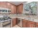 Close up on the kitchen featuring wooden cabinets, stainless steel appliances, and granite countertops at 10584 Peach Creek St, Las Vegas, NV 89179