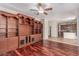 Open-concept living room with custom built-in shelves, hardwood floors, and a seamless transition to the kitchen at 10584 Peach Creek St, Las Vegas, NV 89179