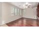 Stylish living room with custom built-in shelves, hardwood floors, and natural light from large windows at 10584 Peach Creek St, Las Vegas, NV 89179