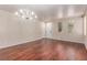 Spacious living room featuring hardwood floors, a decorative chandelier, and an abundance of natural light at 10584 Peach Creek St, Las Vegas, NV 89179