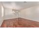 Spacious living room featuring hardwood floors, a decorative chandelier, and a staircase to the second floor at 10584 Peach Creek St, Las Vegas, NV 89179