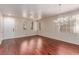 Spacious living room featuring hardwood floors, a decorative chandelier, and an abundance of natural light at 10584 Peach Creek St, Las Vegas, NV 89179