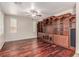 Stylish living room with custom built-in shelves, hardwood floors, and natural light from large windows at 10584 Peach Creek St, Las Vegas, NV 89179