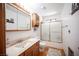 Bright bathroom with a shower-tub combo, wood vanity, and neutral color scheme at 1106 E Athens Ave, Henderson, NV 89015