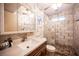 Charming bathroom featuring unique stone-look walls, decorative tile, and a river rock shower floor at 1106 E Athens Ave, Henderson, NV 89015