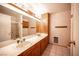 Bathroom features double sinks, wooden cabinets, and neutral decor at 1106 E Athens Ave, Henderson, NV 89015