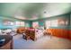 Spacious bedroom features a rustic wood bed frame, lots of windows and comfortable seating at 1106 E Athens Ave, Henderson, NV 89015